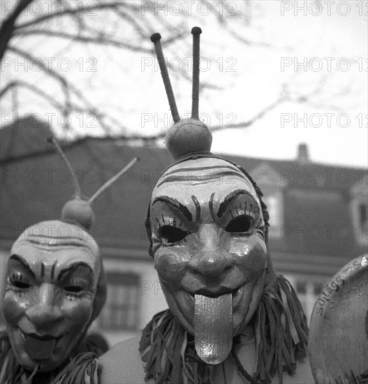 Men with mask stick their tongues out