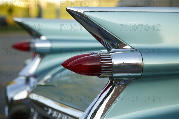 Tail fins with red tail lights of an american vintage car
