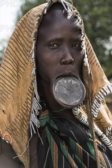 Woman with lip plates and headdress