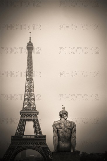 Eiffel tower and l'Homme (the Man) statue by artist Pierre Traverse