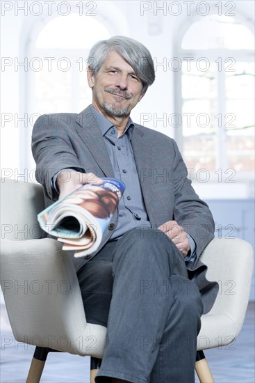 Man with magazine in an office