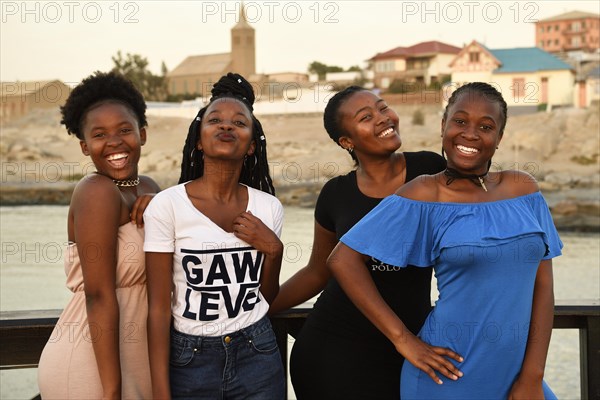 Four young black women posing at the Waterfront