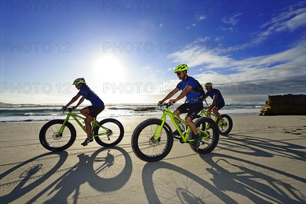 Mountain bikers with Fatbikes at the sandy beach