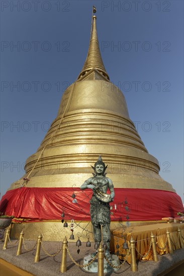 Bronze figure in front of the Golden Chedi on Phu Khao Thong