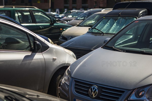 Many cars close in line on a parking lot