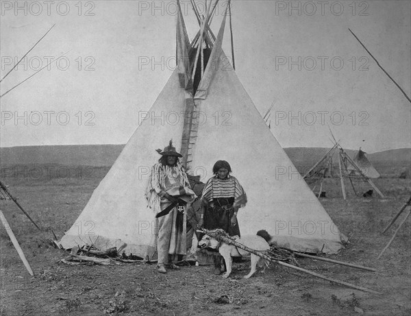 Indian Chief with his wife in front of their tent