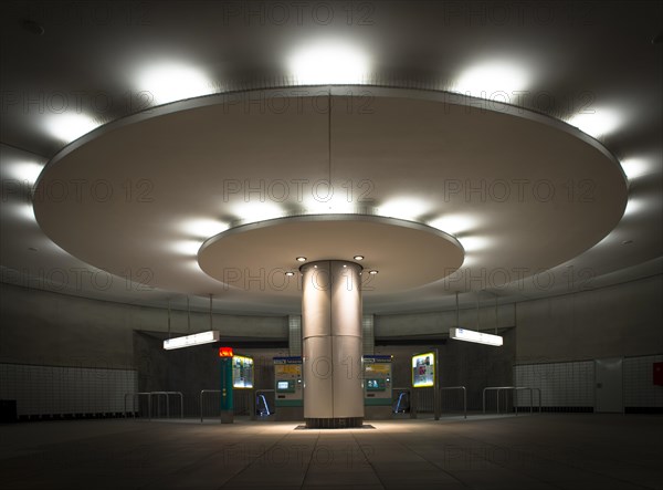 Illuminated column in entrance hall with ticket machine
