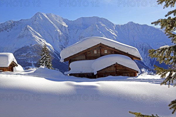 Winter landscape with snow-covered chalet