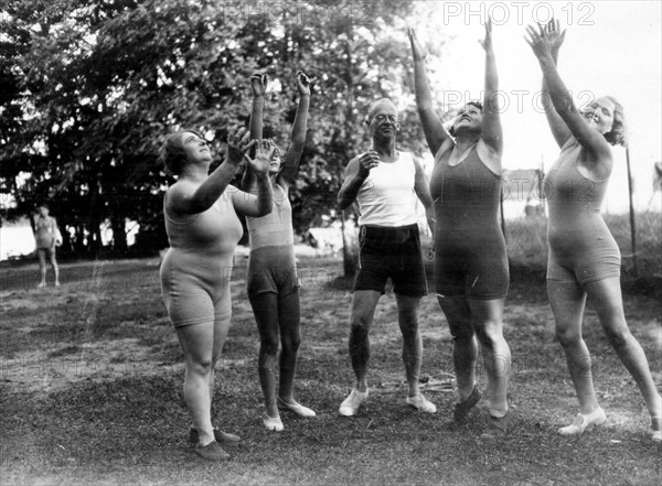 Women and men catch a ball