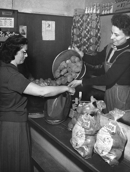 Woman buys potatoes