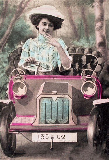 Woman sitting in a car made of cardboard