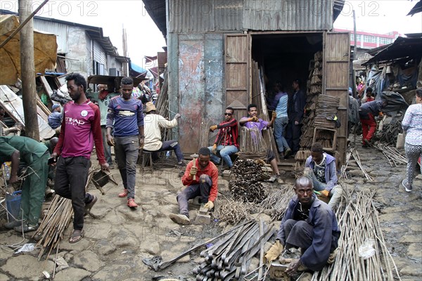 Metal dealer with hardware in front of corrugated-iron huts