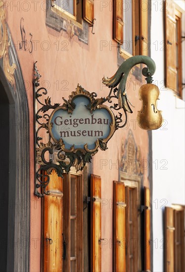 Hanging shop sign at Violin making museum