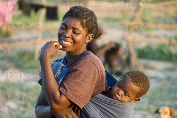 Tonga woman with child on her back