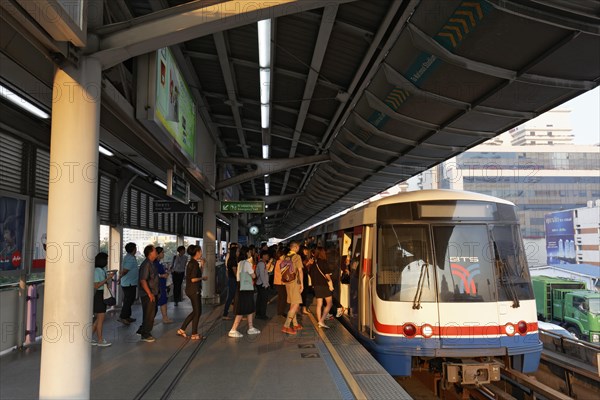 People board the BTS Skytrain in the morning