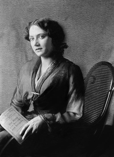 Young woman with book in reading chair