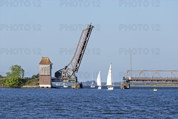 Sailboats sailing through open Schlei bridge