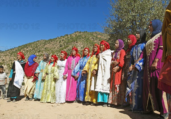 Dancing women in colorful dresses