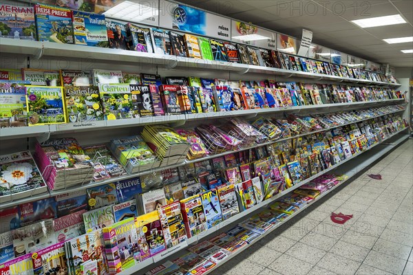 Shelf with magazines in a supermarket