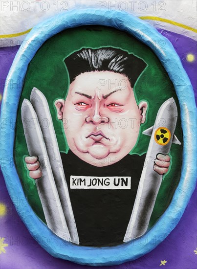 North Vietnamese President Kim Jong-un holds nuclear missile