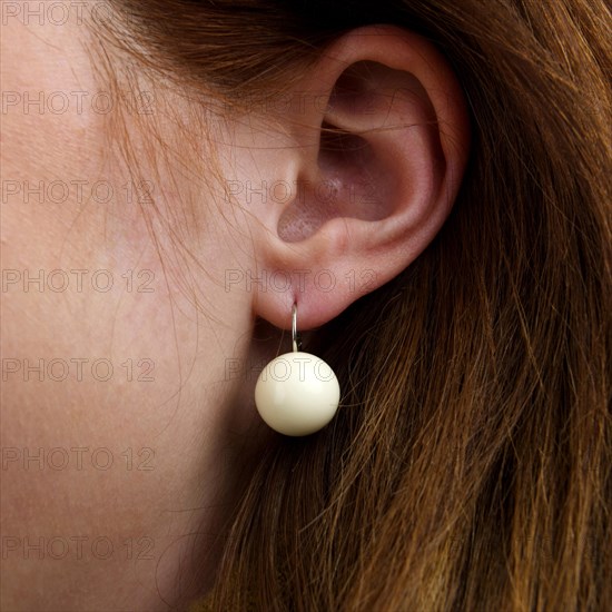 Close-up of a woman's ear with earring