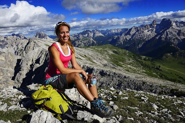 Young female hiker pauses during the ascent from the Prato Piazza to the summit of the Durrenstein