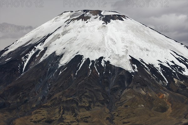 Snow-covered peak volcano Parinacota in the border area of Chile and Bolivia