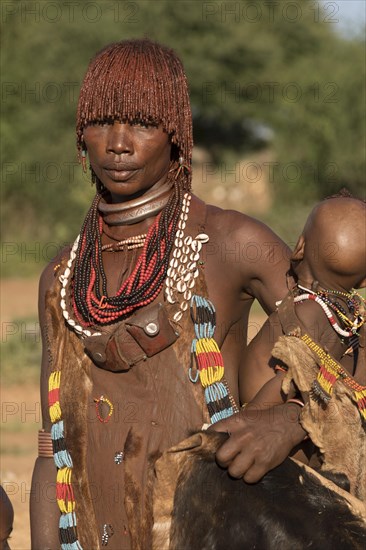 Woman with baby from the Hamer tribe in traditional dress