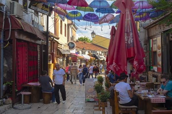 Colorful umbrellas hanging in a street