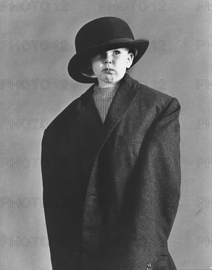 Little boy in large coat and hat