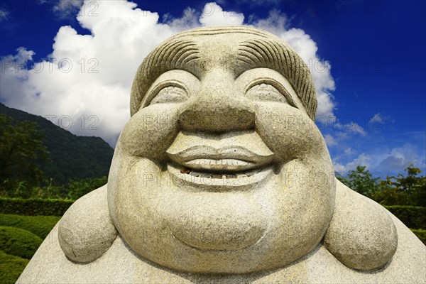 Ebisu Buddha with coins in his mouth