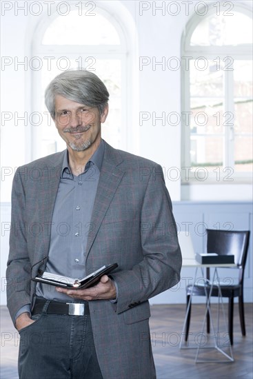 Man with calendar in front of his office window