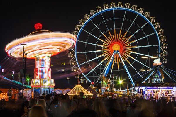 Chain carousel and Ferris wheel at night