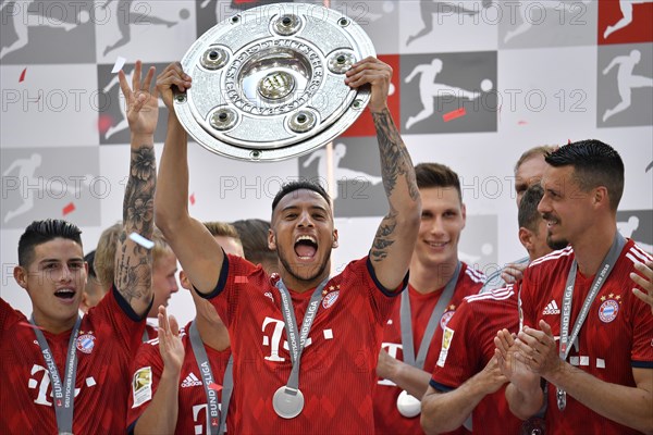 Cheering Corentin Tolisso FC Bayern Munich after handing over the championship cup