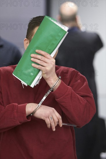 Defendant enters the courtroom in handcuffs