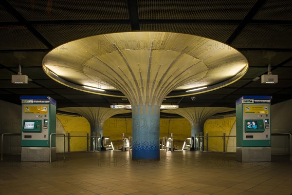 Illuminated column in entrance hall with ticket machine