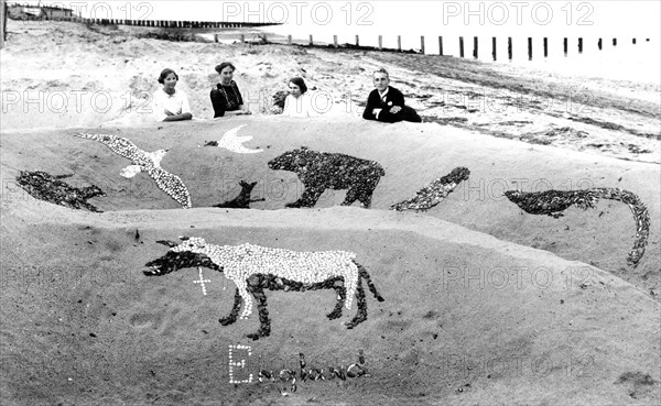 Family on a sandy beach with sandcastle