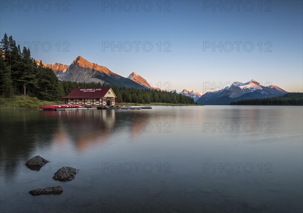 Boathouse with canoes on the shores of Maligne Lake