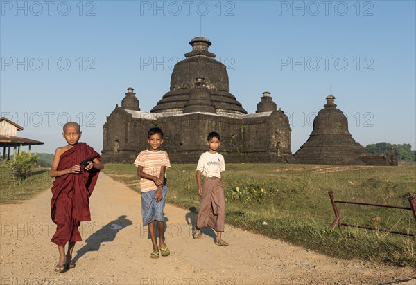 Boys play in front of Laymyetnha Paya
