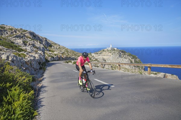 Cyclists on mountain road by Cap de Formentor