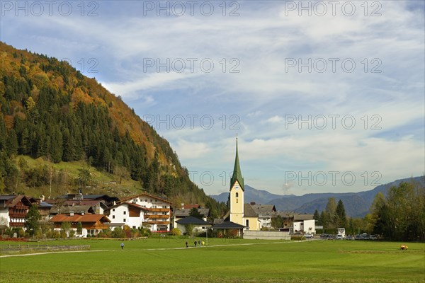 View of village with parish church St. Johannes the Baptist in autumn