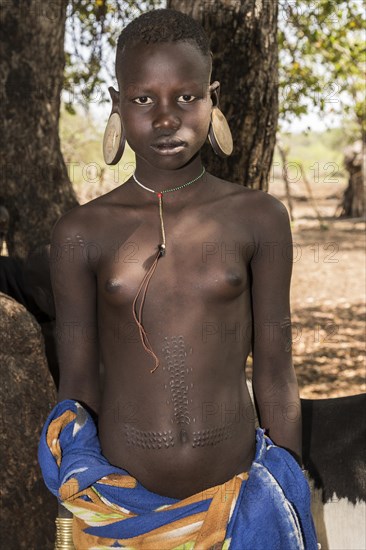 Young woman with ornamental scars on her body