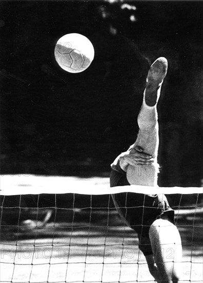 Balancing act at volleyball ca. 1970s