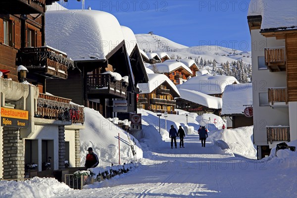 Village road with snow-covered chalets