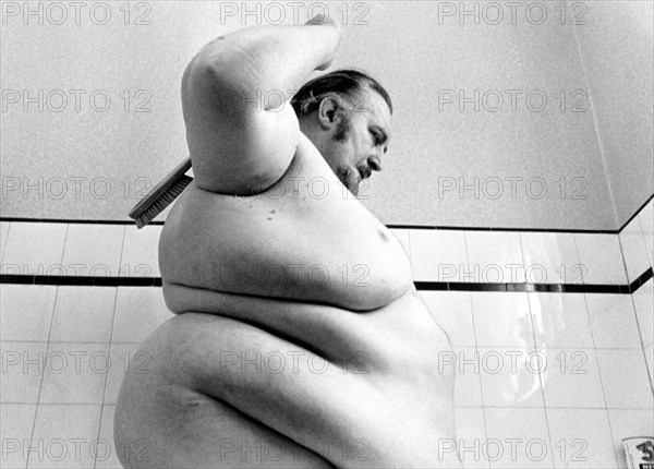 Big man washes himself