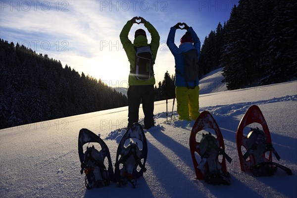 Snowshoe hikers form a heart on the Saukogel