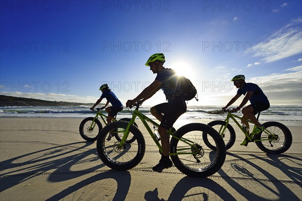 Mountain bikers with Fatbikes at the sandy beach