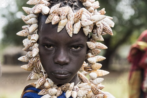 Young woman with headdress made of shells