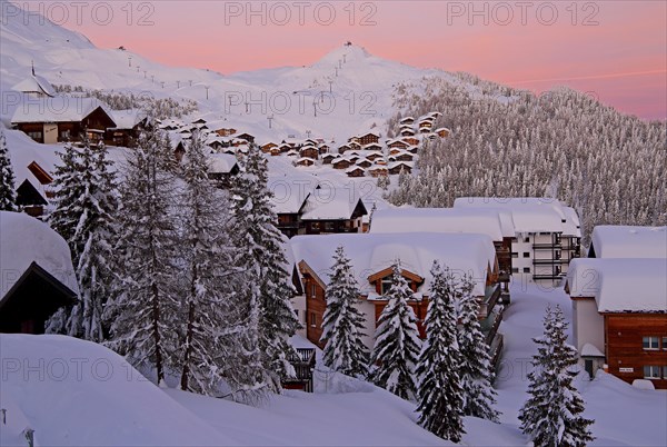 Village view snow-covered at dusk