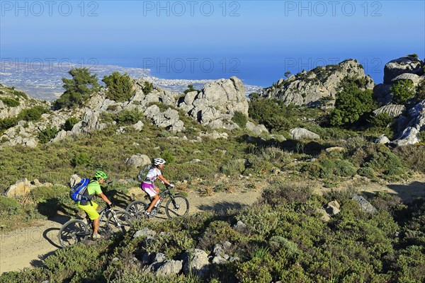 Two mountain bikers ride through Macchia